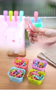 30 pack of colorful plastic clothespins with strong metal springs in a handy storage basket