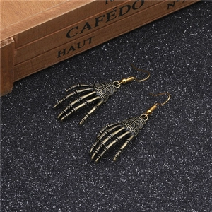 Detailed view of gothic skeleton hand earrings with vintage bronze metal finish