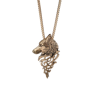 Vintage bronze wolf head pendant necklace for men with tribal flame design on white background