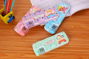 Detailed view of three pastel cartoon pencil cases with built-in sharpeners on desk