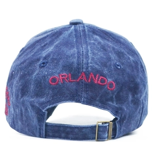 Detail of washed denim baseball cap with Orlando red embroidery and metal buckle strap