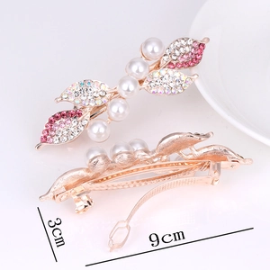 Golden leaf hair clip with pearls and pink rhinestones, measuring 9cm by 3cm long