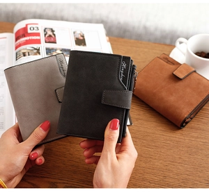 Three suede leather wallets in black, grey, and brown with metal buckles and card slots
