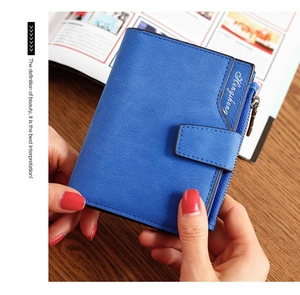 Detail of blue leather wallet showing multi-slot interior and silver zipper pocket
