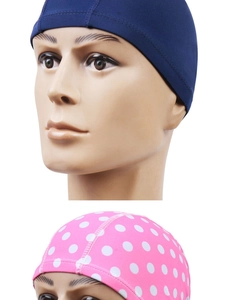 Detailed stitching and fabric texture of navy blue and pink polka dot polyester swim caps