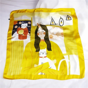 Flat lay of a yellow silk square scarf with illustration of a girl and cat