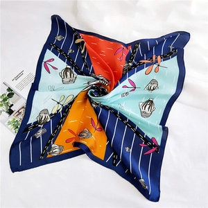 Detailed shot of an artistic print square scarf with floral patterns on white fabric