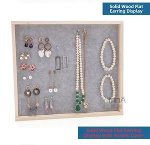 Detail of solid wood jewelry display box with clear acrylic lid and grey velvet interior