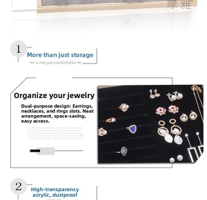 Detail view of acrylic dustproof jewelry box with black velvet ring slots and earring hooks