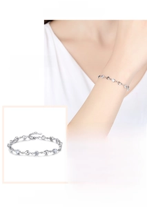 Close-up of S925 sterling silver heart bracelet with sparkling zircon on a female wrist