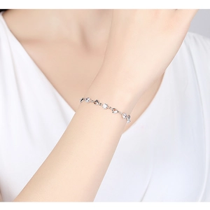 Minimalist 925 sterling silver heart bracelet with sparkling zircons worn on wrist