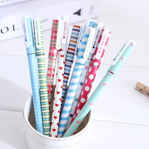 Set of 10 colorful patterned gel pens in a white ceramic cup on a desk background