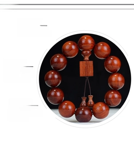 Macro shot of polished Brazilian Rosewood beads with natural grain and tassel detail