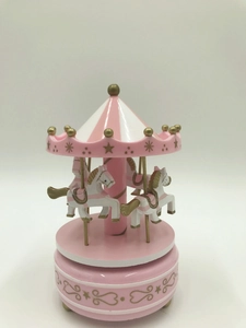 Pink and white carousel music box featuring three horses and golden star patterns