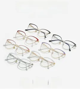 Flat lay of seven colorful cat-eye metal frames in black, red, and rose gold finishes