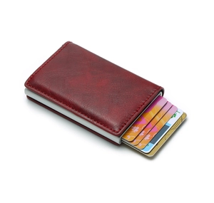 Macro view of red-brown leather wallet showing the automatic popup card mechanism