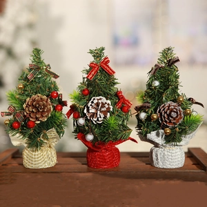 Three 20cm mini table Christmas trees with pine cones and berries on a wood tray