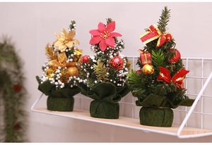 Detailed close-up of three 20cm mini Christmas trees with bows and festive ornaments