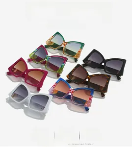 Flat lay of colorful oversized bow-style square sunglasses with gradient lenses