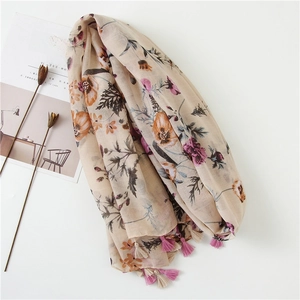 Detail of floral printed scarf showing delicate tassels and breathable cotton-linen fabric