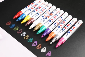 Close-up of 12 vibrant waterproof oil-based paint markers with medium point nibs