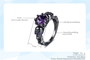 Macro detail of black gold skull ring featuring an 8mm purple cubic zirconia stone