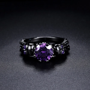 Vintage black gold skull ring for women with large purple zircon in a punk gothic style