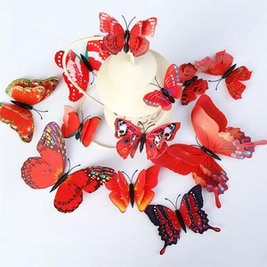 Detailed view of 12 red 3D double-layer butterfly wall stickers around a cage decor