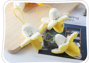 Three cute plush banana keychain charms with smiling faces and yellow hanging loops