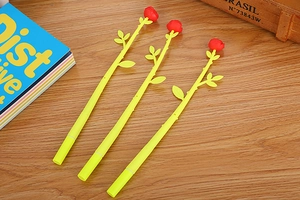 Detailed view of creative rose shaped pens with yellow barrels on a rustic wooden desk