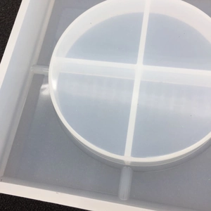 Macro detail of a four-grid round silicone mold for DIY resin coasters and crafts