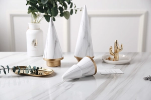 Macro detail of Nordic marble ceramic cones with frosted gold bases for modern home decor
