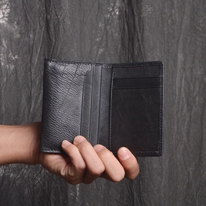 Detail of black genuine leather card holder with multiple slots and lychee texture