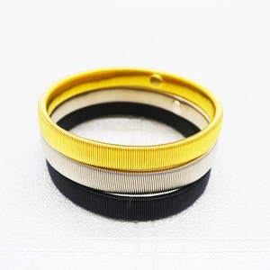 Men's metal spring armbands set in gold, silver, and black finishes on white background