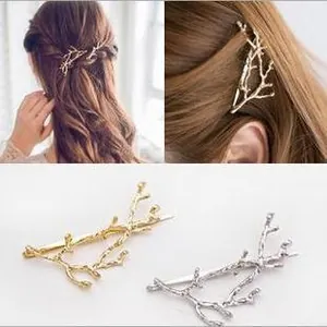 Detail of deer antler hair clips in gold and silver finish with branch texture