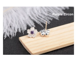 Close-up of S925 silver cherry blossom stud earrings with purple cubic zirconia stone
