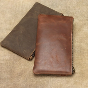 Close-up of vintage crazy horse leather wallets in dark brown and reddish brown colors