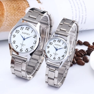 Silver quartz watch set for couples featuring stretch bands and clear numeric dials