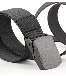 Detail of black nylon belt with premium plastic buckle on minimalist white background