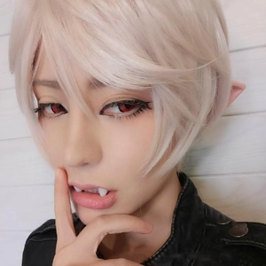 Close-up of elf cosplay set featuring white wig, pointed ears, fangs, and red lenses