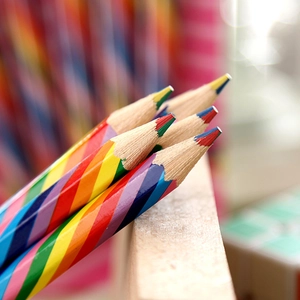 Macro shot of rainbow wooden pencil tips showing multi-colored lead and texture