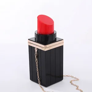 Lipstick-shaped acrylic evening bag with gold metal trim and elegant chain strap