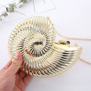 Golden shell-shaped acrylic evening clutch bag with mirror finish and chain strap