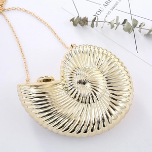 Elegant gold seashell clutch bag with glossy spiral texture and a fine metal chain strap