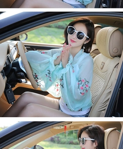 Detailed view of light blue chiffon sun protection top with delicate floral embroidery