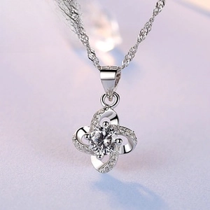 Macro shot of S925 silver four-leaf clover heart pendant with pavé cubic zirconia