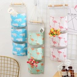 Detail view of hanging canvas storage bags with polar bear and flamingo prints
