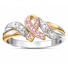 Detailed close-up of pink ribbon ring featuring two-tone metal and micro-pave zircons