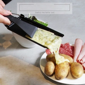 Swiss Raclette set with non-stick melting tray pouring melted cheese over appetizers