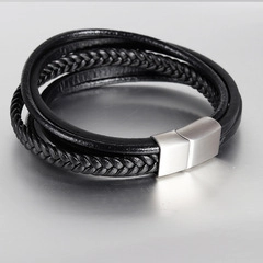 Detailed macro view of black braided leather layers and silver magnetic metal clasp